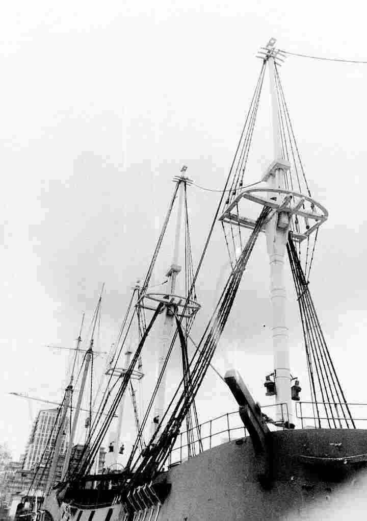 A black and white photo of the masts of two ships.