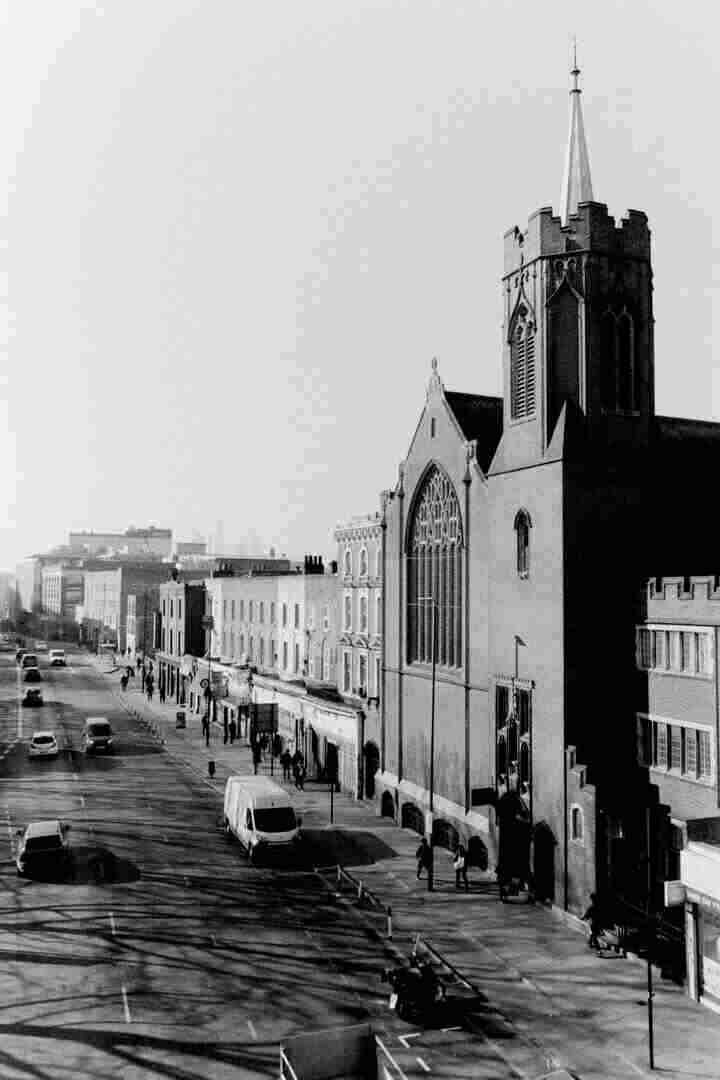 A large church looms over a quiet city street.