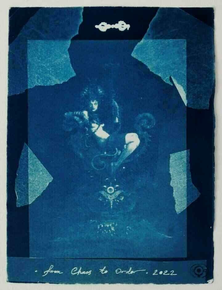 A cyanotype print of a succubus lounging in a throne. There is text saying 'from Chaos to Order 2022' at the bottom.