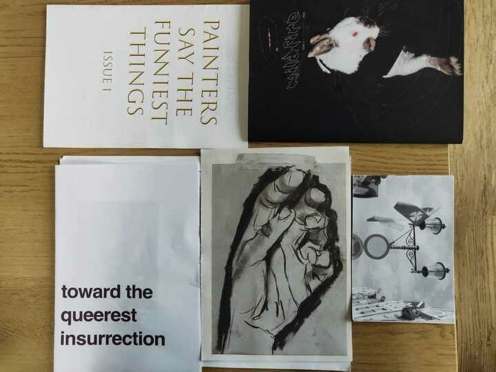 A stack of anarchist zines and flyers.